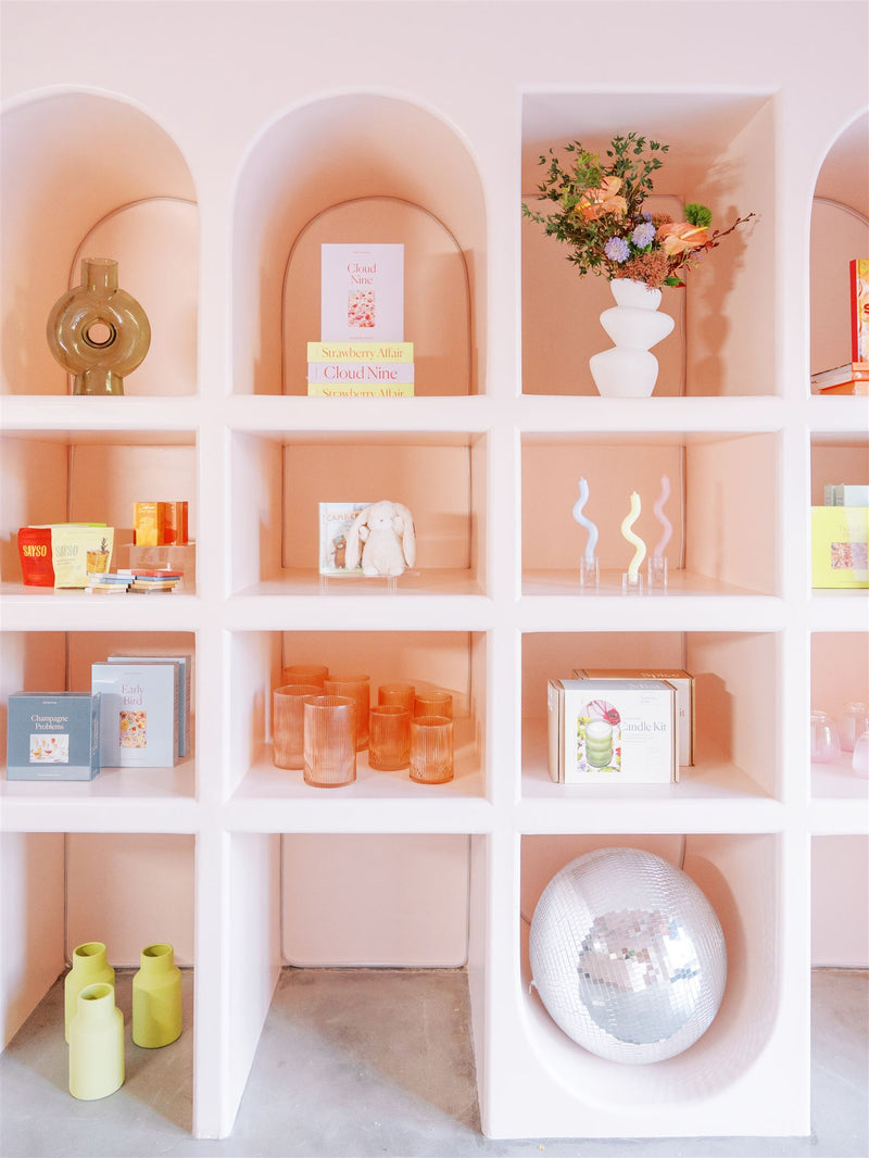 Arched gift shelves with candles, vases and flowers at JJ's Flower Shop in Dunwoody